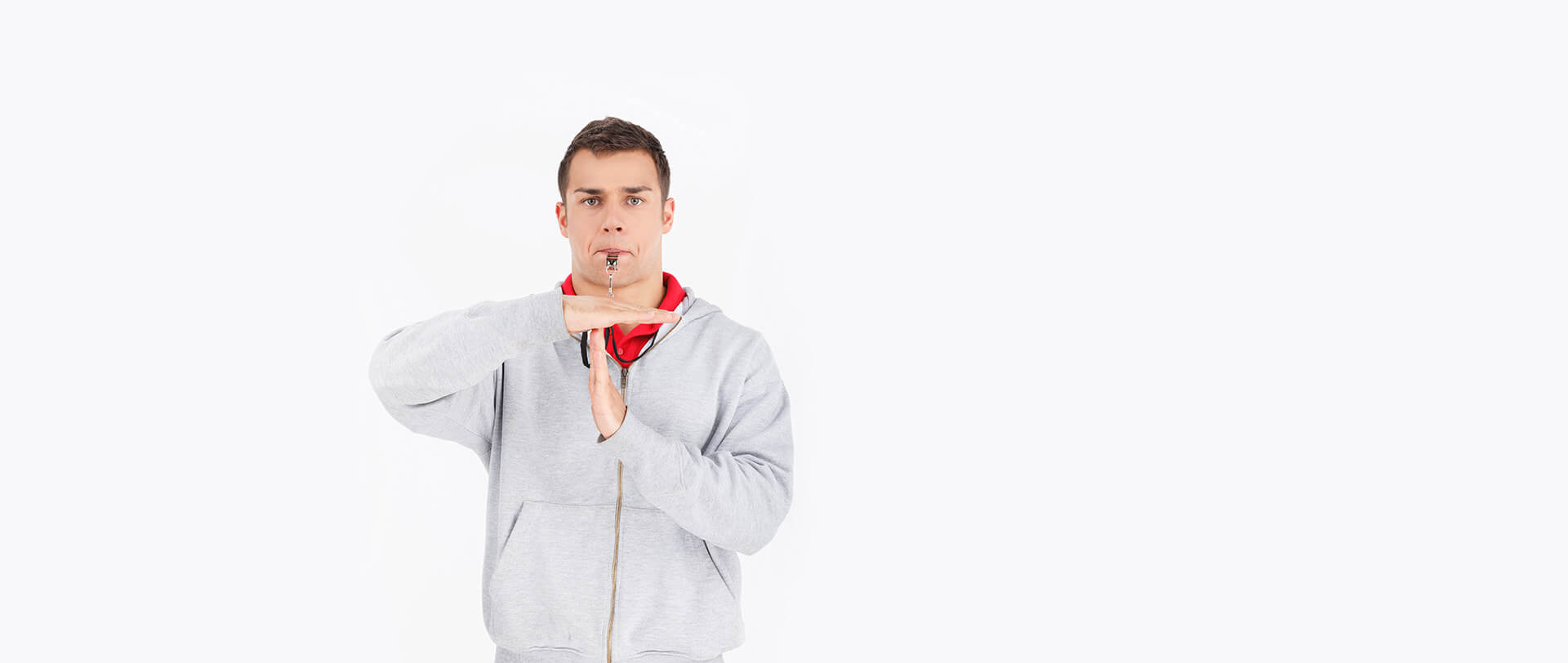 A health coach, blowing a whistle and making the “time-out” gesture
